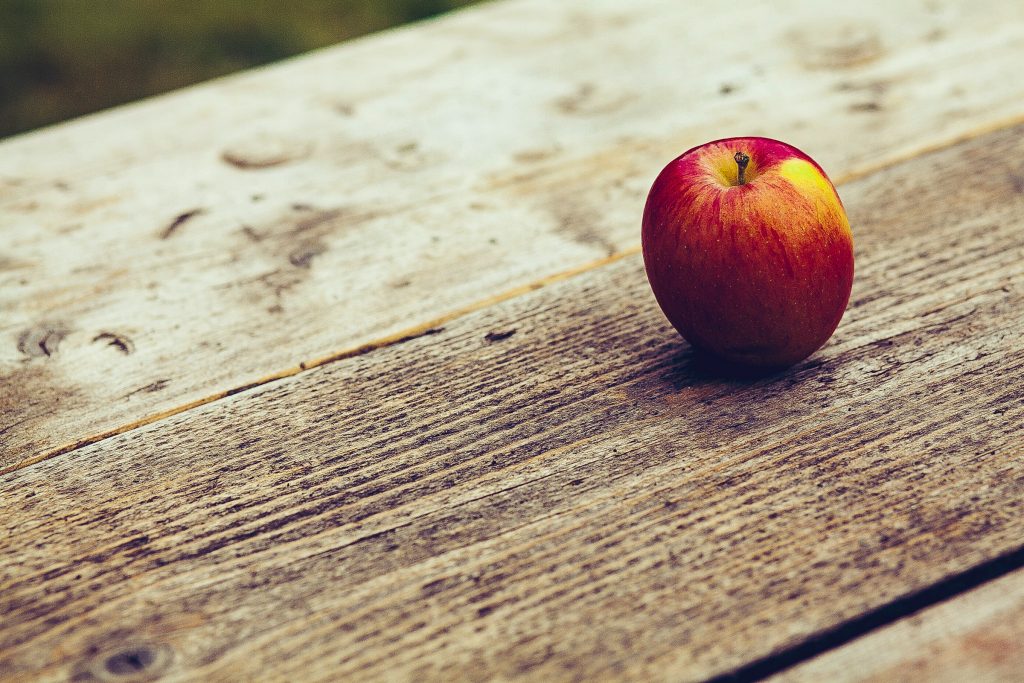 An apple on a table.